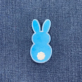 Blue bunny-shaped patch on denim fabric