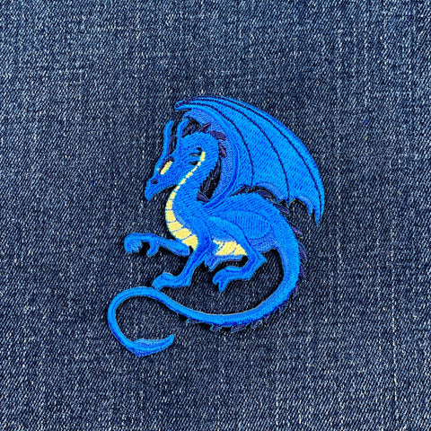 Blue dragon patch on denim fabric
