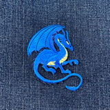 Blue dragon patch on denim fabric
