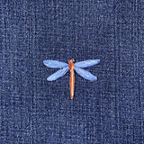 Embroidered dragonfly patch on denim fabric