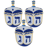 Three embroidered dreidels on a white background