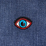 Eye-shaped patch on denim fabric