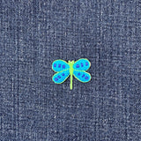 Blue and green dragonfly patch on denim fabric
