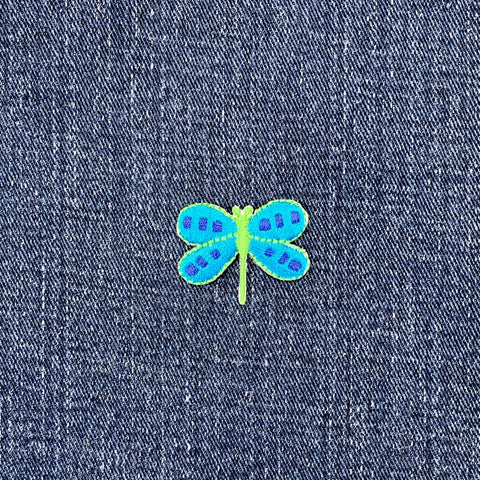 Blue and green dragonfly patch on denim fabric