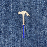 Hammer-shaped patch on a denim background