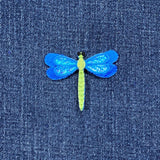 Blue dragonfly patch on denim fabric