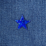 Blue star-shaped sequin patch on denim fabric