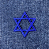 Blue embroidered Star of David patch on denim fabric
