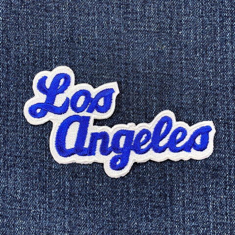 Embroidered patch with 'Los Angeles' text on denim fabric