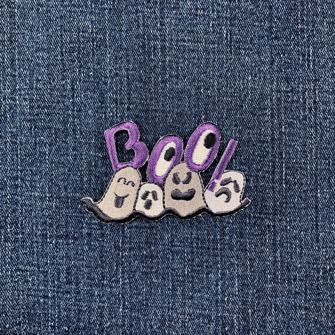 Embroidered patch with ghosts and 'BOO!' text on denim fabric
