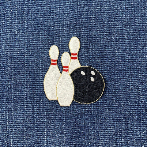 Bowling pin and ball patch on denim fabric
