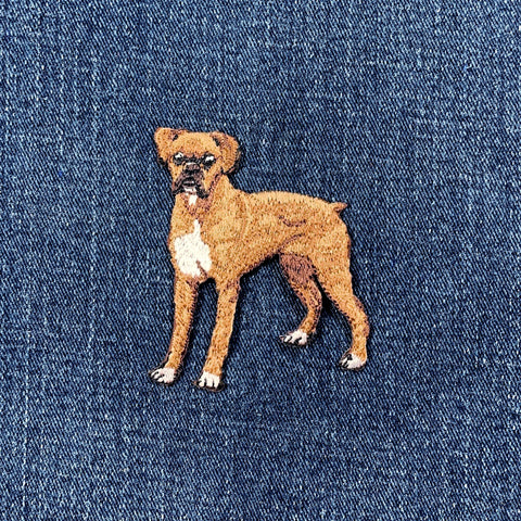 Embroidered boxer patch of a dog on blue denim fabric