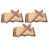 Three embroidered patches depicting a cross over a Bible against a white background.