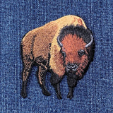 Embroidered buffalo applique patch with a brown, black, and beige design on a denim background.