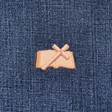 Patch of a brown and tan bible on blue denim fabric