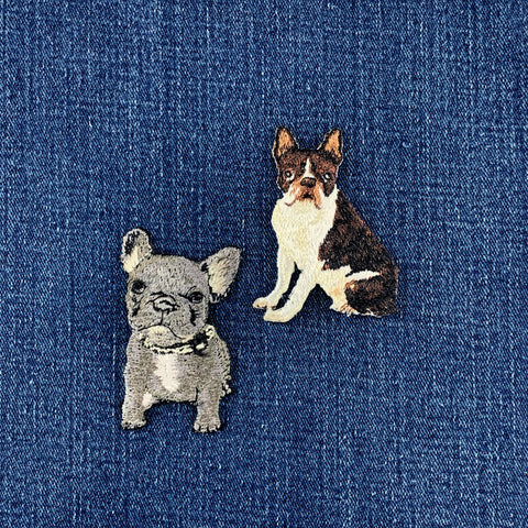Two dog patches on a denim fabric background