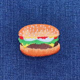 a cheeseburger patch on a denim   background