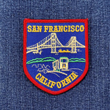 Embroidered patch of San Francisco, California with a bridge design on denim fabric.