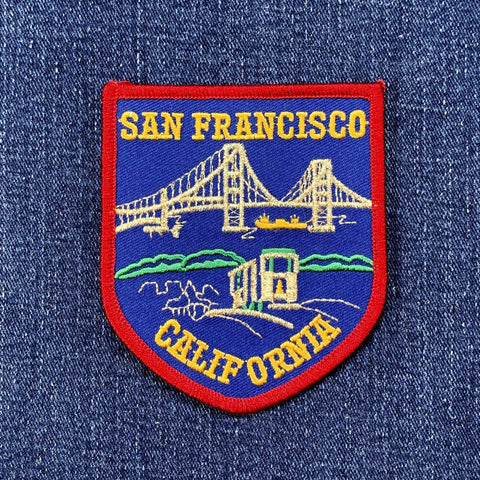 Embroidered patch of San Francisco, California with a bridge design on denim fabric.
