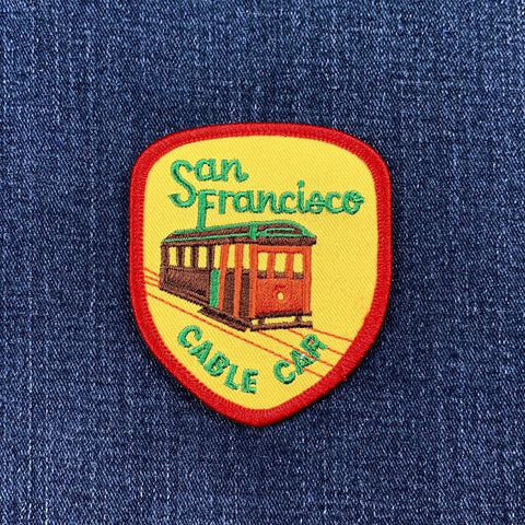 Embroidered patch of a San Francisco cable car on denim fabric