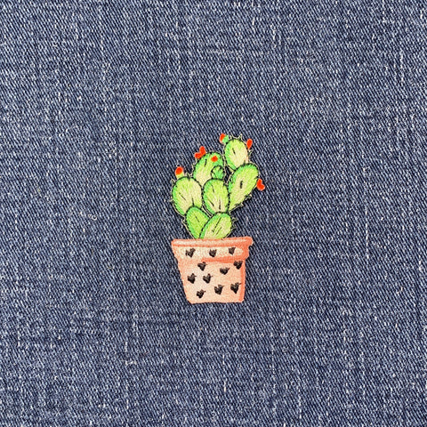 Embroidered cactus patch on denim fabric