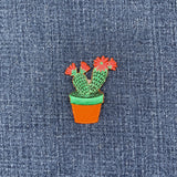 Cactus plant patch with pink flowers on denim fabric