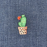 Embroidered cactus patch on denim fabric