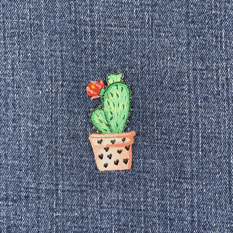 Embroidered cactus patch on denim fabric