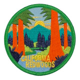 Embroidered patch of California Redwoods with trees and mountains.