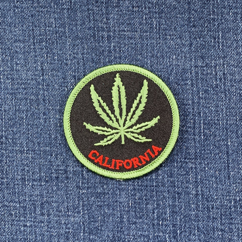 Patch with a cannabis leaf and 'California' text on denim fabric