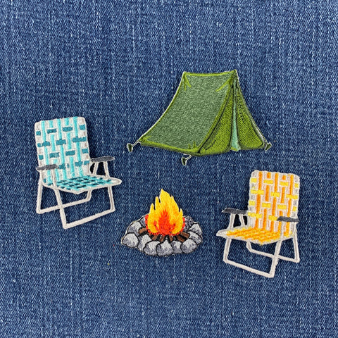 4 patches: a turquoise lawn chair patch, a yellow lawn chair patch, a green tent patch, and a camp fire patch displayed on a denim background