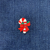 candy cane patch with a red and green bow on a denim background