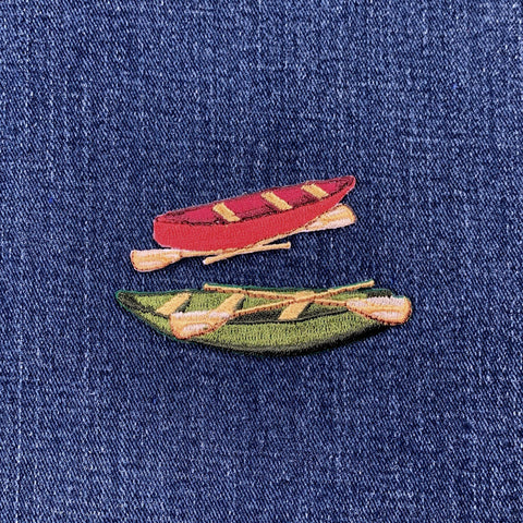 Embroidered patch set of a red canoe and green canoe on denim fabric