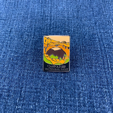 Pin with a Capitol Reef National Park landscape design on a blue denim background