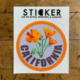 California poppy sticker displayed on a wood table