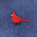 Red bird patch on blue denim fabric