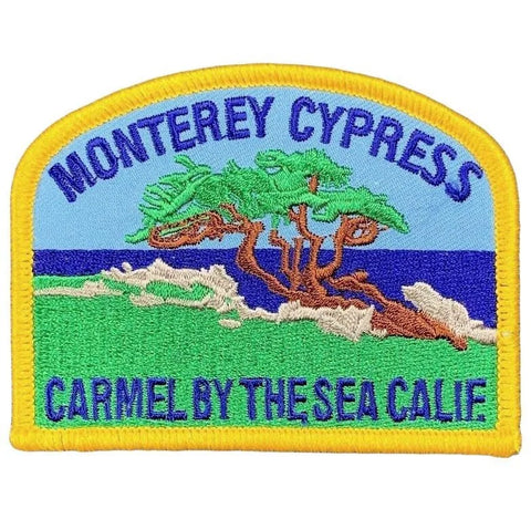 Embroidered patch of Monterey Cypress with the text 'Monterey Cypress Carmel By The Sea Calif.' on a white background