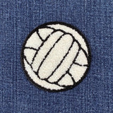 Volleyball patch on a denim background