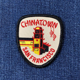 Patch with 'Chinatown San Francisco' text and building illustration on a blue denim background