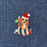 Embroidered patch of a beagle dog wearing a red Santa hat, surrounded by colorful Christmas ornaments on a denim background.