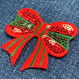 Red sequin bow patch on denim fabric