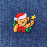 Embroidered Christmas bear patch on denim fabric