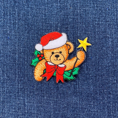 Embroidered Christmas bear patch on denim fabric