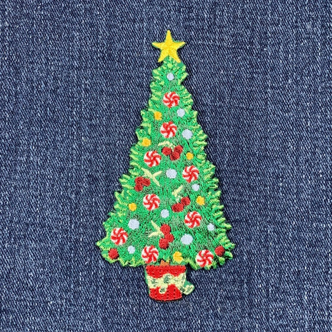 Embroidered Christmas tree patch on denim fabric