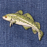 Cod fish patch on a denim background