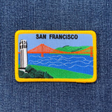 A rectangular embroidered patch featuring the Golden Gate Bridge, Coit Tower, and SF Bay with the text 'SAN FRANCISCO' on top. 