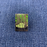 Pin with congaree national park design on a blue denim background