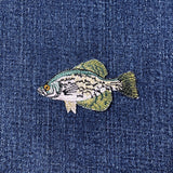 Embroidered fish patch on denim fabric