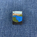 Pin with a crater lake national park mountain and lake design on a denim background