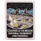 A patch featuring a stylized landscape of Craters of the Moon National Monument and Preserve with mountains and stars.